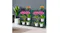 Side-by-side green steel plant shelves holding colourful potted plants against a grey wall Side-by-side green steel plant shelves holding colourful potted plants against a grey wall