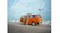 A coastal scene with a drone near an orange van A coastal scene with a drone near an orange van