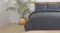 Charcoal Malmo comforter set styled on a bed with two matching pillows Charcoal Malmo comforter set styled on a bed with two matching pillows