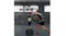 A person throwing a punch at a freestanding boxing trainer in an indoor training space A person throwing a punch at a freestanding boxing trainer in an indoor training space
