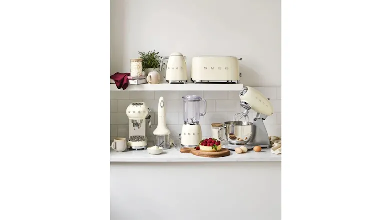 A view of a clean white kitchen countertop with all of the available cream coloured Smeg appliances displayed A view of a clean white kitchen countertop with all of the available cream coloured Smeg appliances displayed