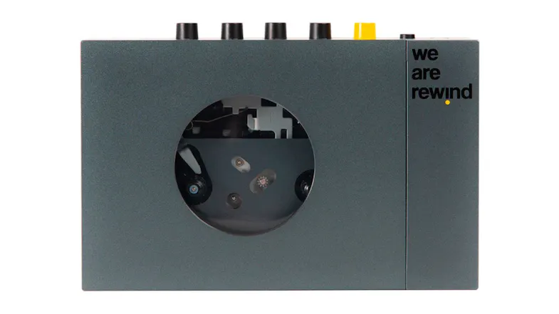 We Are Rewind "Keith" Portable Cassette Player in grey with visible tape mechanism window We Are Rewind "Keith" Portable Cassette Player in grey with visible tape mechanism window