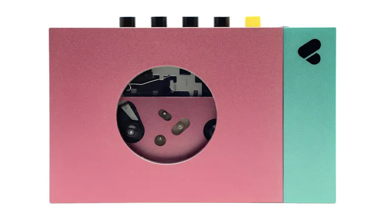 We Are Rewind "Edith" Portable Cassette Player in pink and green with visible tape mechanism window We Are Rewind "Edith" Portable Cassette Player in pink and green with visible tape mechanism window