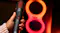 Hand holding the microphone in front of a glowing figure-eight light Hand holding the microphone in front of a glowing figure-eight light