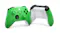 Two Xbox controllers: front view in green with black buttons, rear view showing white back panel Two Xbox controllers: front view in green with black buttons, rear view showing white back panel