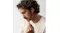 Close-up profile of a man with curly hair wearing Skullcandy headphones Close-up profile of a man with curly hair wearing Skullcandy headphones