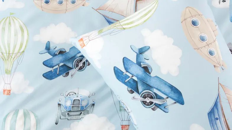 Detailed fabric view highlighting watercolour biplanes, balloons, and vintage vehicles floating among soft clouds Detailed fabric view highlighting watercolour biplanes, balloons, and vintage vehicles floating among soft clouds