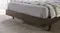 Low-angle view of the dark wood frame and tapered cylindrical legs Low-angle view of the dark wood frame and tapered cylindrical legs