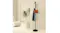 Black Levede coat rack holding a hat, coat, and bag in a minimal beige room with a potted plant Black Levede coat rack holding a hat, coat, and bag in a minimal beige room with a potted plant