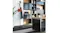 Black coat rack holding a bag and jacket in a modern office with shelving and a desk Black coat rack holding a bag and jacket in a modern office with shelving and a desk