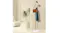 Gold coat rack styled in a minimalist room, holding a hat, bag, and coat near a plant and seating Gold coat rack styled in a minimalist room, holding a hat, bag, and coat near a plant and seating
