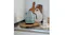 Minimalist kitchen scene featuring a Porsche edition Smeg kettle on a wooden board with a ceramic mug Minimalist kitchen scene featuring a Porsche edition Smeg kettle on a wooden board with a ceramic mug
