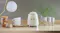 Side view of the Smeg kettle on a counter with white mugs Side view of the Smeg kettle on a counter with white mugs