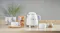 Cream kettle centred among tea accessories on a marble counter Cream kettle centred among tea accessories on a marble counter