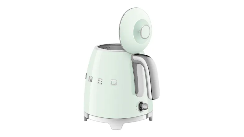 Rear side view of the Smeg mini kettle with the lid open for filling Rear side view of the Smeg mini kettle with the lid open for filling