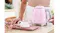A person pressing the silver lever on the pastel pink kettle A person pressing the silver lever on the pastel pink kettle