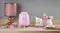 Pink kettle on a counter with floral teacups and a copper lamp Pink kettle on a counter with floral teacups and a copper lamp