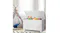 Open white toy box filled with toys beside a play tent and a patterned rug in a bright room Open white toy box filled with toys beside a play tent and a patterned rug in a bright room