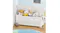 White toy storage chest with the lid open, holding pillows and soft toys in a playroom setting White toy storage chest with the lid open, holding pillows and soft toys in a playroom setting