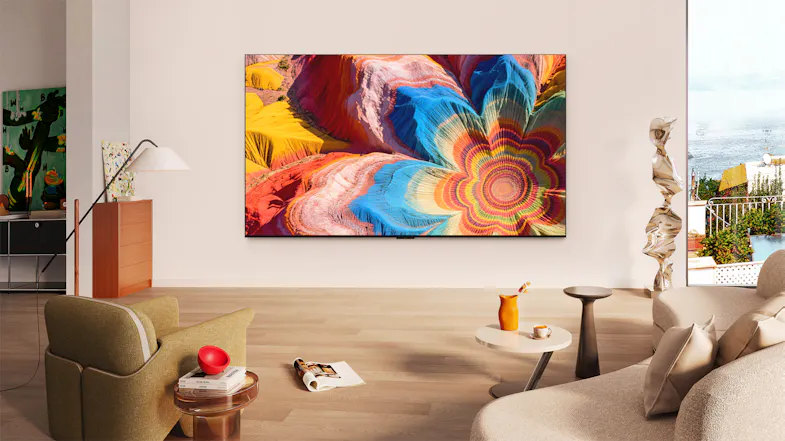 Lifestyle image of the TCL 65‑inch C6L TV wall‑mounted in a bright, modern living room Lifestyle image of the TCL 65‑inch C6L TV wall‑mounted in a bright, modern living room