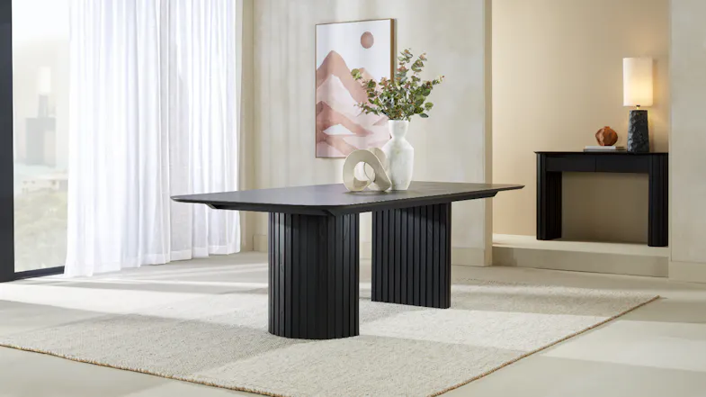 Dining table displayed without chairs, showing the rectangular top and rounded corners Dining table displayed without chairs, showing the rectangular top and rounded corners