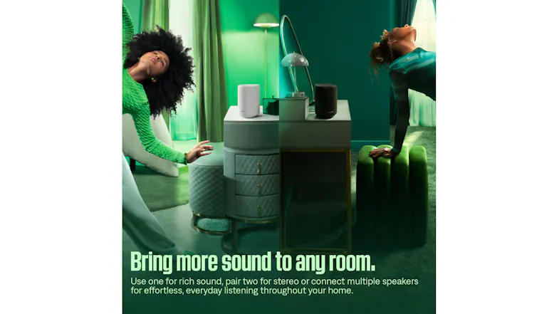 Lifestyle promotional image showing multiple Bose wireless speakers in black and white placed on furniture Lifestyle promotional image showing multiple Bose wireless speakers in black and white placed on furniture