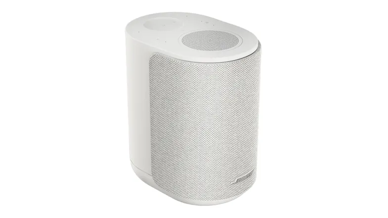 Alternate angled view of the white Bose speaker, highlighting the textured fabric grille and curved edges Alternate angled view of the white Bose speaker, highlighting the textured fabric grille and curved edges