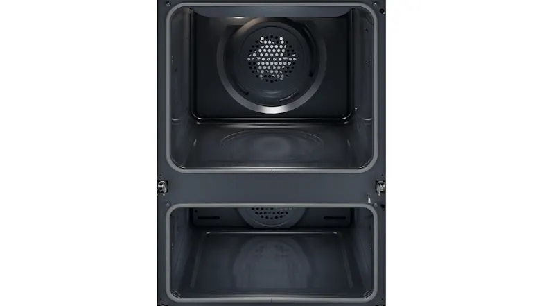 Empty double oven interior highlighting the circular rear fan and heating element Empty double oven interior highlighting the circular rear fan and heating element