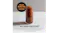 A tall glass filled with a dark brown frozen drink and a striped straw sits on a countertop A tall glass filled with a dark brown frozen drink and a striped straw sits on a countertop