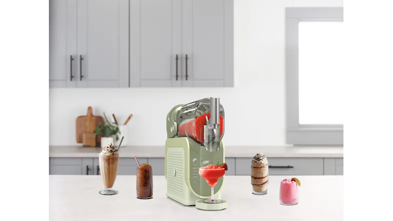 The SLUSHi machine dispenses a red frozen drink into a margarita glass The SLUSHi machine dispenses a red frozen drink into a margarita glass