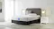 Modern bedroom setup featuring an Incredi‑Bed medium mattress on a dark base with an upholstered headboard and bedside lamps Modern bedroom setup featuring an Incredi‑Bed medium mattress on a dark base with an upholstered headboard and bedside lamps