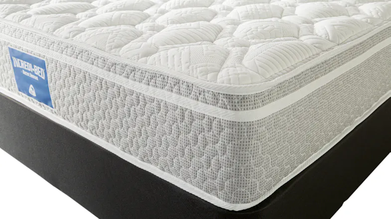 A close‑up angled view of the Incredi‑Bed mattress showing quilted top layers, textured side panels, and a premium fabric finish A close‑up angled view of the Incredi‑Bed mattress showing quilted top layers, textured side panels, and a premium fabric finish