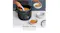 The pressure cooker with the lid removed, while cooked rice and grains are being served into bowls The pressure cooker with the lid removed, while cooked rice and grains are being served into bowls