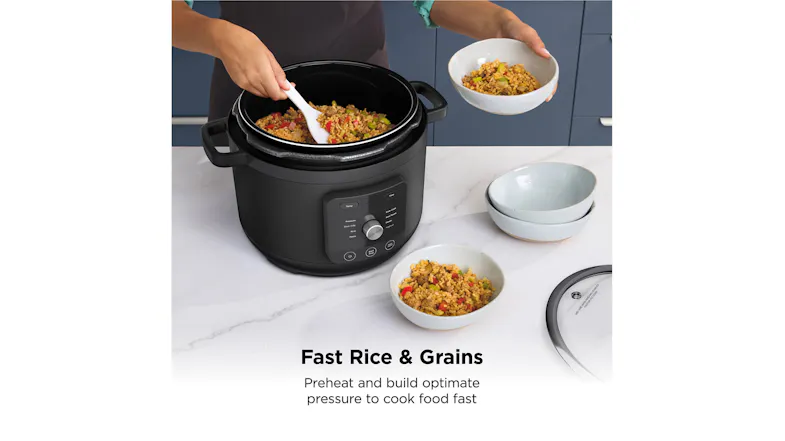 The pressure cooker with the lid removed, while cooked rice and grains are being served into bowls The pressure cooker with the lid removed, while cooked rice and grains are being served into bowls