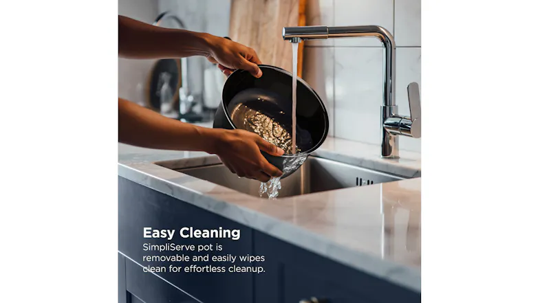 Hands rinsing the removable SimpliServe pot under a kitchen tap Hands rinsing the removable SimpliServe pot under a kitchen tap
