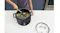 A similar top‑down view of vegetables sautéing inside the pot, with the glass lid placed nearby on the bench A similar top‑down view of vegetables sautéing inside the pot, with the glass lid placed nearby on the bench