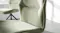 Detailed view of olive fabric chair highlighting woven texture, stitching, and gently curved backrest and seat Detailed view of olive fabric chair highlighting woven texture, stitching, and gently curved backrest and seat