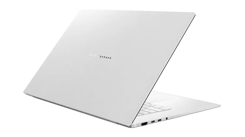 Angled rear view of a closed silver ASUS Zenbook laptop, showing the lid logo and slim profile with ports Angled rear view of a closed silver ASUS Zenbook laptop, showing the lid logo and slim profile with ports