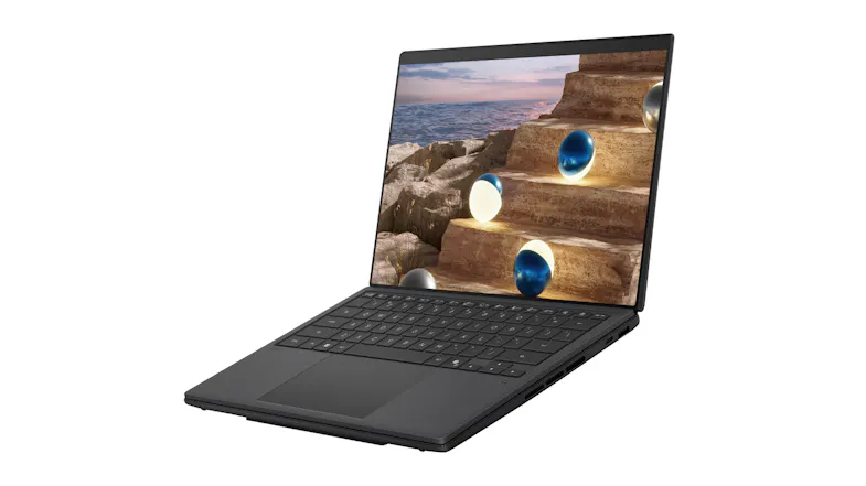 Three‑quarter view of a slim black laptop open, with the screen displaying stone steps by the ocean with glowing orbs Three‑quarter view of a slim black laptop open, with the screen displaying stone steps by the ocean with glowing orbs