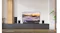 LG OLED TV on a wooden stand showcasing a snowy mountain LG OLED TV on a wooden stand showcasing a snowy mountain