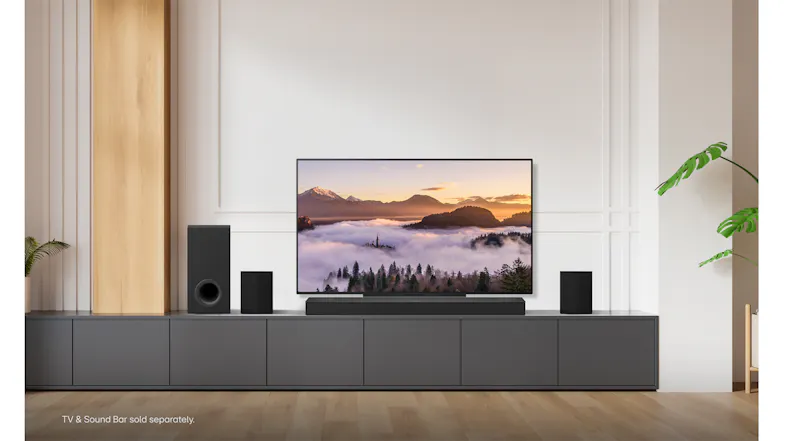 LG OLED TV on a wooden stand showcasing a snowy mountain LG OLED TV on a wooden stand showcasing a snowy mountain