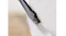 Crevice tool attachment cleaning tight edges and corners along the wall and floor for precise dust removal Crevice tool attachment cleaning tight edges and corners along the wall and floor for precise dust removal