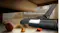 Vacuum cleaner with LED brush head removing dust under the sofa and around small toys on the floor Vacuum cleaner with LED brush head removing dust under the sofa and around small toys on the floor