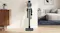 Cordless stick vacuum standing upright in a modern living room with a sleek design and compact storage setup Cordless stick vacuum standing upright in a modern living room with a sleek design and compact storage setup