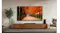 A modern living room with a TV displaying an autumn tree-lined path, along with a wooden console, speakers, and chairs A modern living room with a TV displaying an autumn tree-lined path, along with a wooden console, speakers, and chairs