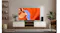 A modern living room with a TV displaying a red canyon rock formation, along with a wooden console, plants, and a speaker A modern living room with a TV displaying a red canyon rock formation, along with a wooden console, plants, and a speaker