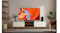 Modern living room with a TV showing an orange canyon image, a soundbar on the console, shelves, plants, and a leather chair Modern living room with a TV showing an orange canyon image, a soundbar on the console, shelves, plants, and a leather chair