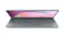 Lenovo grey notebook open in low-profile, showing keyboard and soft pink gradient wallpaper on screen Lenovo grey notebook open in low-profile, showing keyboard and soft pink gradient wallpaper on screen