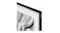 A close-up of a black frame corner with Samsung branding, showing abstract grey and white brushstrokes inside A close-up of a black frame corner with Samsung branding, showing abstract grey and white brushstrokes inside