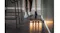 A person using the Bissell Handstick Vacuum Cleaner is cleaning crumbs along the kitchen base cabinets on a dark tile floor near stools and a sock A person using the Bissell Handstick Vacuum Cleaner is cleaning crumbs along the kitchen base cabinets on a dark tile floor near stools and a sock